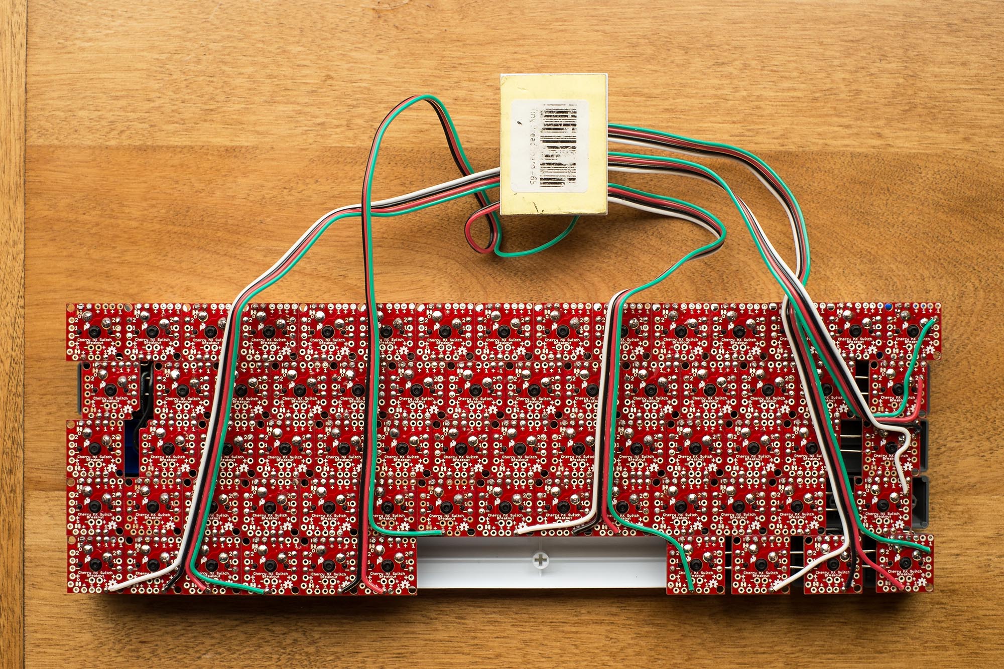 Bottom view of keyboard with switches soldered on and roughly wired to microcontroller