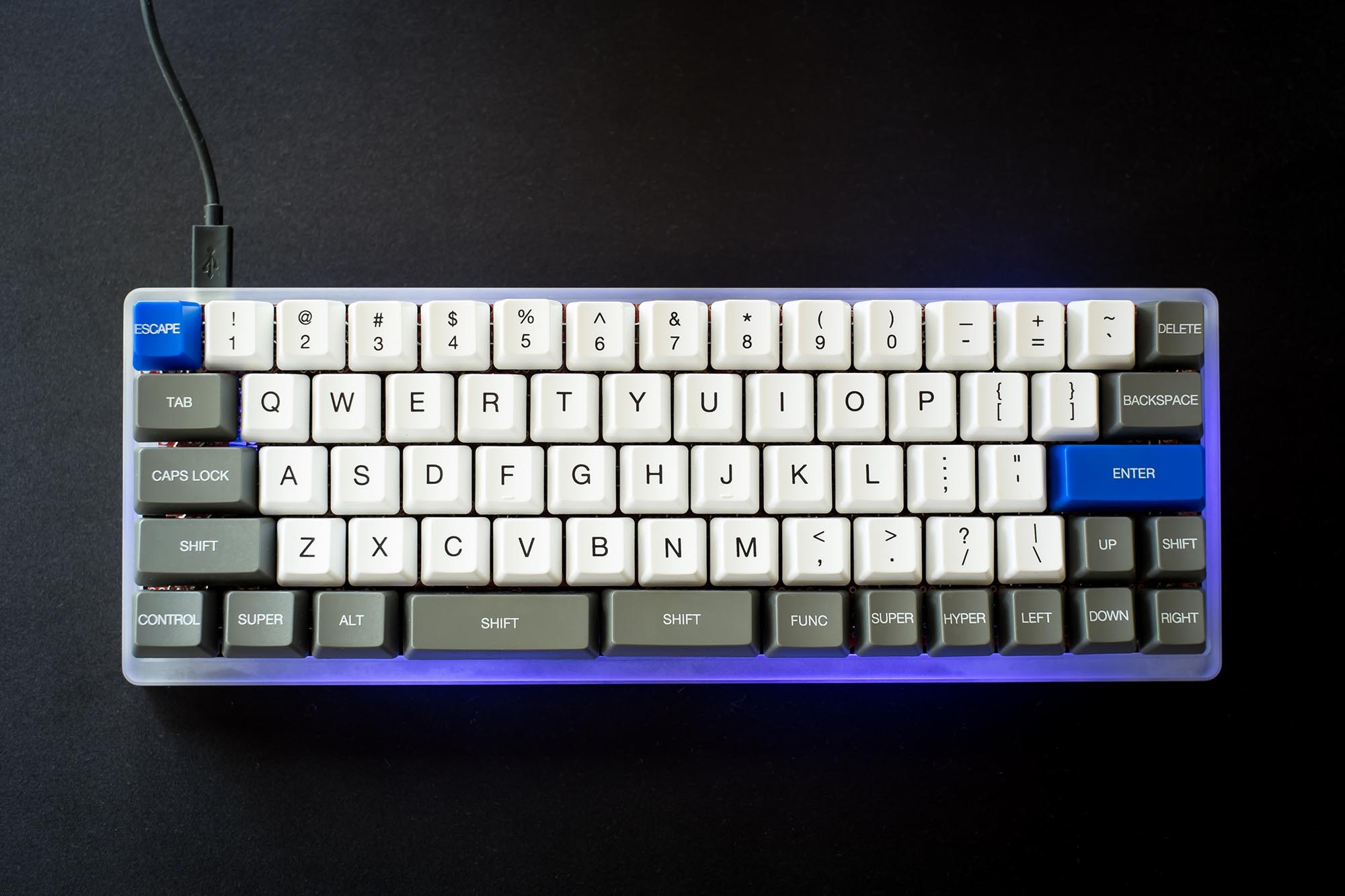 Top view of keyboard with acrylic case and purple glowing LEDs