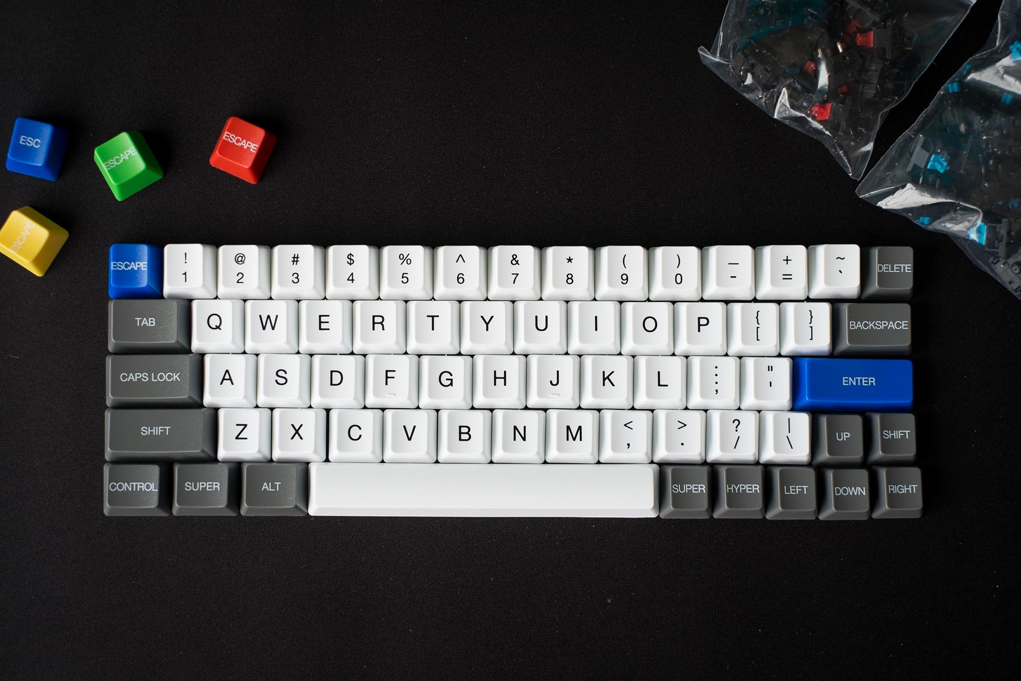 Keycaps arranged on a desk in the layout of the final keyboard